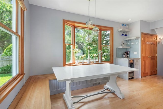 137 Congdon Ave, North Kingstown, RI 02852 - dining space featuring a dry bar, plenty of natural light, light wood-style flooring, and beverage cooler
