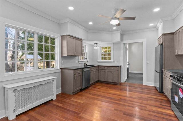 81 Old N Rd, South Kingstown, RI 02881 - kitchen featuring a sink, appliances with stainless steel finishes, radiator, dark wood-style flooring, and a ceiling fan