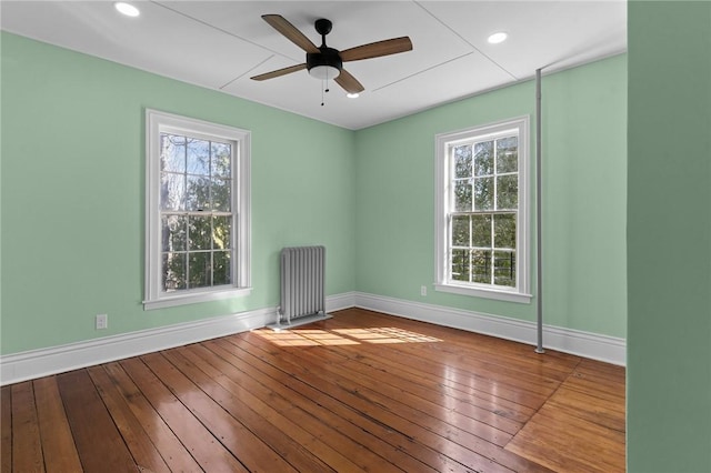 81 Old N Rd, South Kingstown, RI 02881 - spare room with radiator heating unit, baseboards, wood-type flooring, and recessed lighting