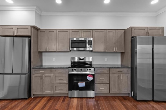 81 Old N Rd, South Kingstown, RI 02881 - kitchen featuring stainless steel appliances, crown molding, dark wood-style flooring, and dark stone counters