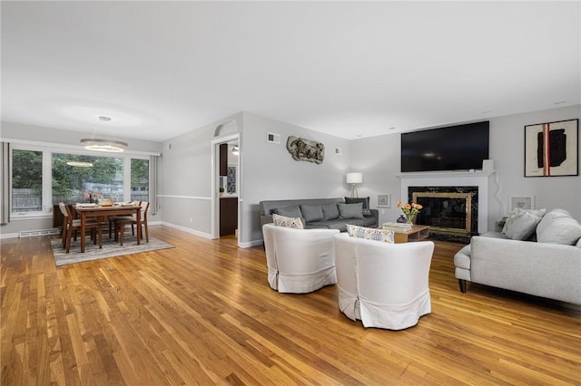 14 Twin Oak Dr, Warwick, RI 02889 - living room with light wood finished floors and a premium fireplace