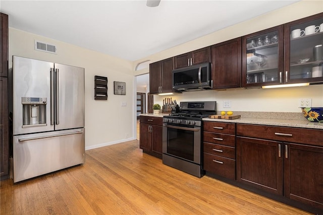 14 Twin Oak Dr, Warwick, RI 02889 - kitchen with stainless steel appliances, light wood-style flooring, dark brown cabinets, and glass insert cabinets