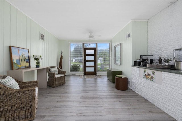 14 Twin Oak Dr, Warwick, RI 02889 - living room featuring ceiling fan, wood finished floors, ornamental molding, and wooden walls