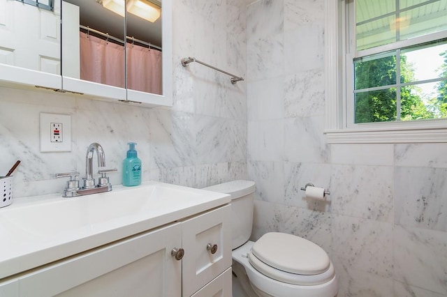 223 Corey Ln, Middletown, RI 02842 - bathroom with vanity, tile walls, and decorative backsplash