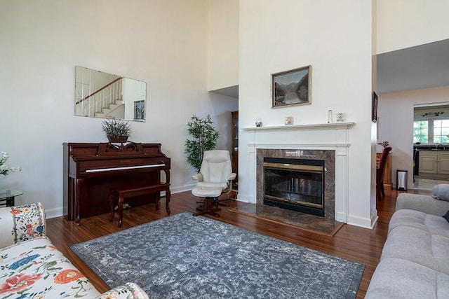 223 Corey Ln, Middletown, RI 02842 - living room with a towering ceiling, wood finished floors, a premium fireplace, and stairs