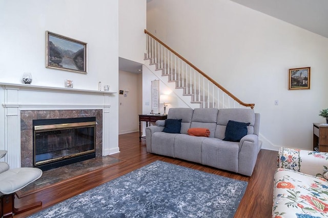 223 Corey Ln, Middletown, RI 02842 - living area with wood finished floors, stairway, a fireplace, and a towering ceiling