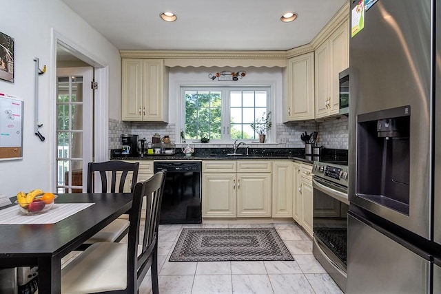 223 Corey Ln, Middletown, RI 02842 - kitchen with appliances with stainless steel finishes, cream cabinets, tasteful backsplash, recessed lighting, and dark stone countertops