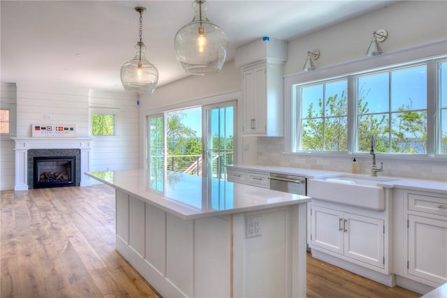 0 Surf Dr, Bristol, RI 02809 - kitchen featuring a sink, dishwasher, white cabinetry, and light wood finished floors