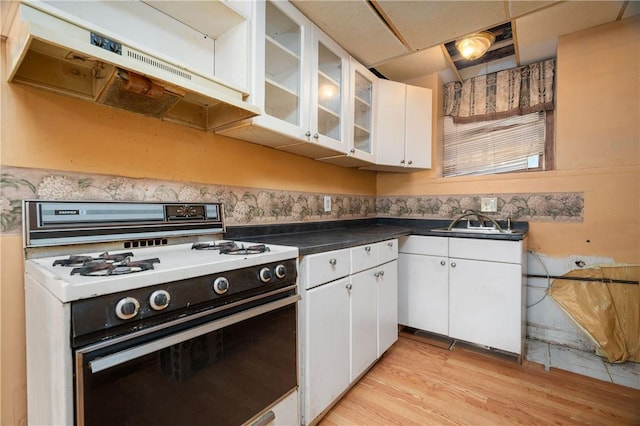 21 Diana Ave, Smithfield, RI 02917 - kitchen featuring gas range gas stove, white cabinets, light wood-style floors, ventilation hood, and dark countertops