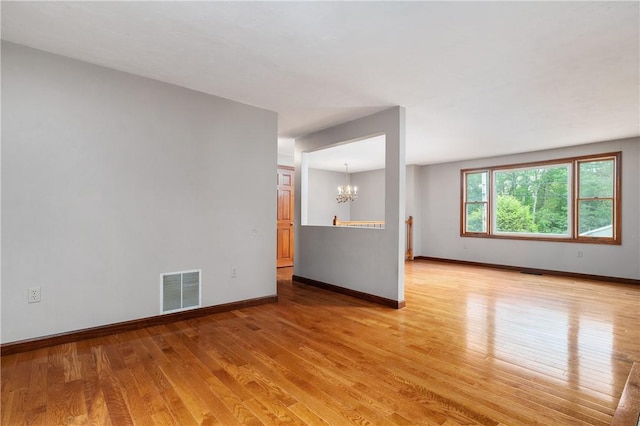 21 Diana Ave, Smithfield, RI 02917 - empty room featuring a chandelier, light wood-type flooring, and baseboards