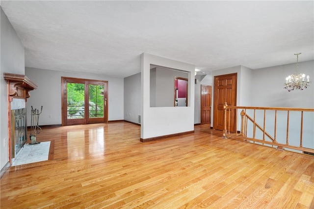 21 Diana Ave, Smithfield, RI 02917 - unfurnished living room featuring wood finished floors, a chandelier, baseboards, and a fireplace with flush hearth