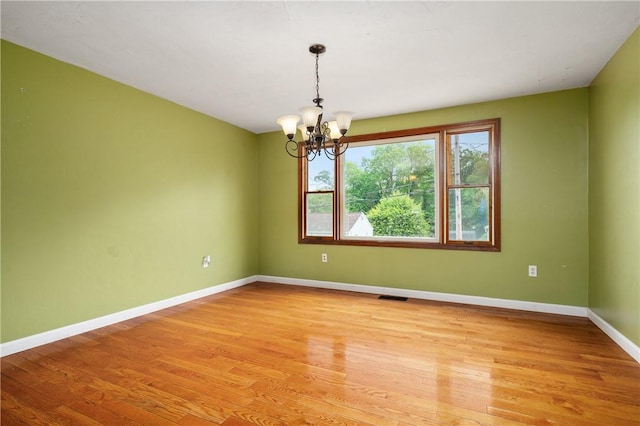 21 Diana Ave, Smithfield, RI 02917 - spare room featuring a chandelier, light wood-style flooring, and baseboards