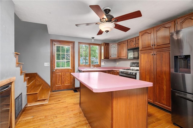 21 Diana Ave, Smithfield, RI 02917 - kitchen featuring stainless steel refrigerator with ice dispenser, white gas range, black microwave, a sink, and light wood finished floors