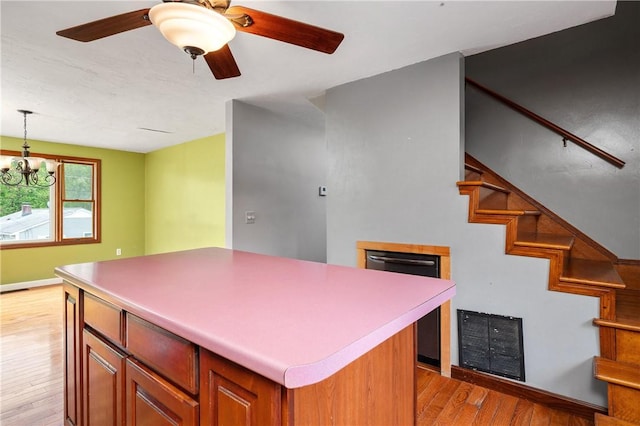21 Diana Ave, Smithfield, RI 02917 - kitchen featuring light wood finished floors, a center island, a chandelier, decorative light fixtures, and a ceiling fan