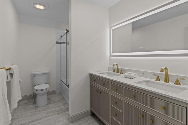 8 J H Dwyer Dr, Middletown, RI 02842 - full bath featuring toilet, double vanity, shower / bath combination with glass door, and baseboards