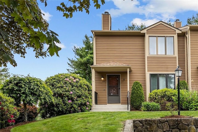 2 Tamarac Dr Unit A, Smithfield, RI 02828 - view of front facade featuring a chimney and a front yard
