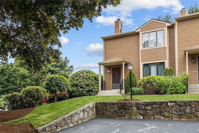 2 Tamarac Dr Unit A, Smithfield, RI 02828 - view of front of home with a chimney and a front lawn