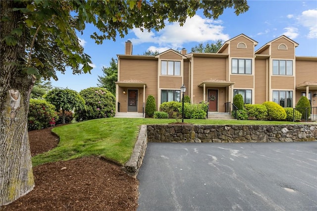 2 Tamarac Dr Unit A, Smithfield, RI 02828 - view of front of property featuring a chimney and a front yard