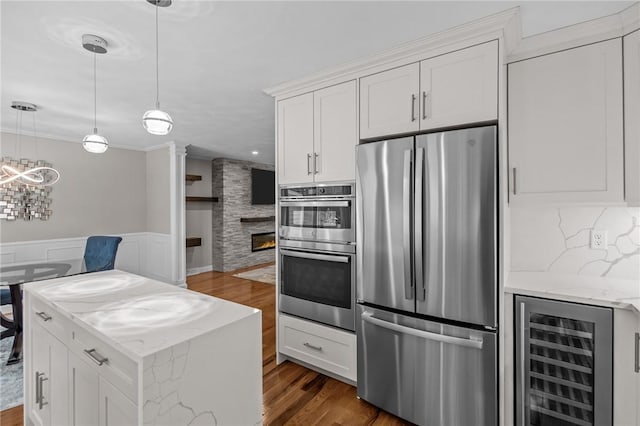 2 Tamarac Dr Unit A, Smithfield, RI 02828 - kitchen featuring appliances with stainless steel finishes, beverage cooler, dark wood-style floors, white cabinetry, and wainscoting