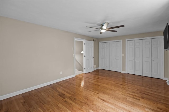 2 Tamarac Dr Unit A, Smithfield, RI 02828 - unfurnished bedroom with baseboards, light wood-style floors, multiple closets, and a ceiling fan