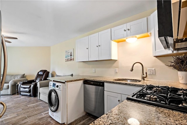 3940 Post Rd Unit 30, Warwick, RI 02886 - kitchen featuring dishwasher, washer / dryer, a sink, open floor plan, and wood finished floors