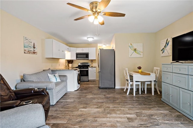 3940 Post Rd Unit 30, Warwick, RI 02886 - living area featuring ceiling fan, dark wood finished floors, and baseboards