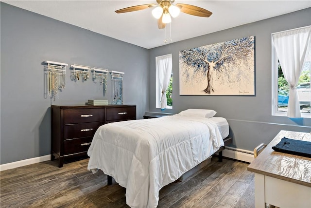 3940 Post Rd Unit 30, Warwick, RI 02886 - bedroom with dark wood-type flooring, baseboard heating, baseboards, and ceiling fan