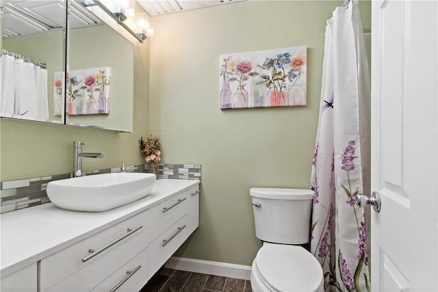3940 Post Rd Unit 30, Warwick, RI 02886 - full bathroom featuring vanity, decorative backsplash, toilet, and wood finished floors