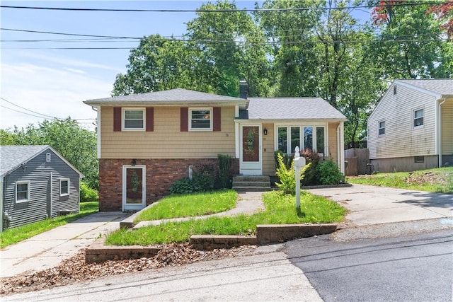 31 Hornbine St, Cranston, RI 02910 - split level home featuring brick siding and a chimney