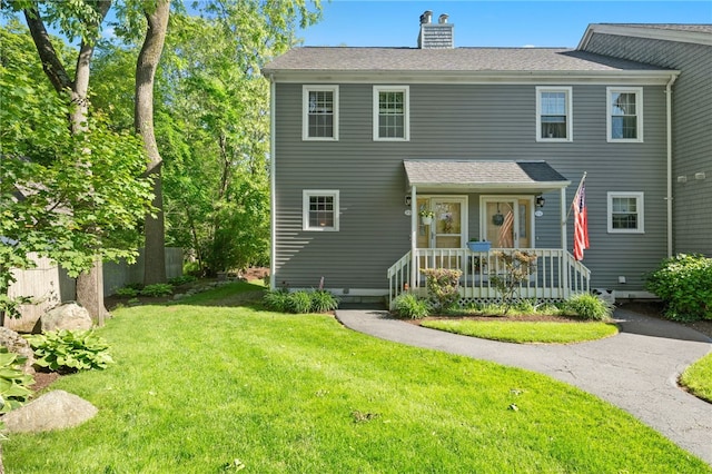 99 Post Rd Unit F1, Warwick, RI 02888 - view of front of property featuring a front lawn, a chimney, and a shingled roof