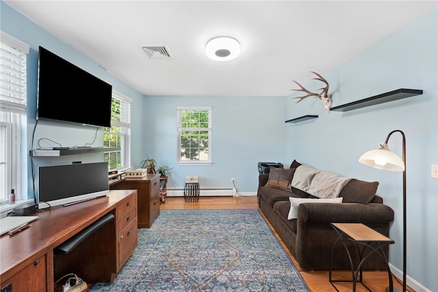 99 Post Rd Unit F1, Warwick, RI 02888 - home office with a baseboard heating unit, light wood-style flooring, and baseboards