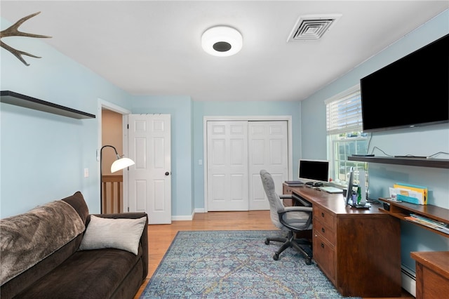 99 Post Rd Unit F1, Warwick, RI 02888 - office area with baseboard heating and light wood-style floors