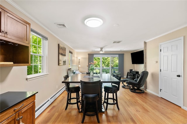 99 Post Rd Unit F1, Warwick, RI 02888 - dining space featuring a baseboard heating unit, light wood-style flooring, ornamental molding, ceiling fan, and baseboards