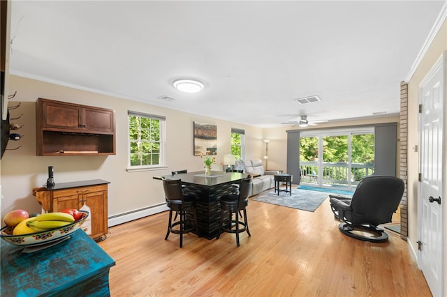 99 Post Rd Unit F1, Warwick, RI 02888 - dining area with a baseboard heating unit, light wood-type flooring, ornamental molding, and a ceiling fan