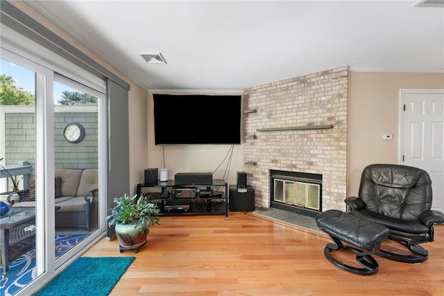 99 Post Rd Unit F1, Warwick, RI 02888 - living area featuring ornamental molding, a fireplace, and wood finished floors