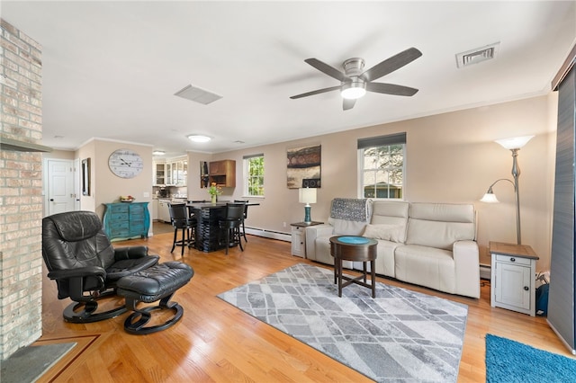99 Post Rd Unit F1, Warwick, RI 02888 - living room featuring a baseboard radiator, a ceiling fan, wood finished floors, and ornamental molding