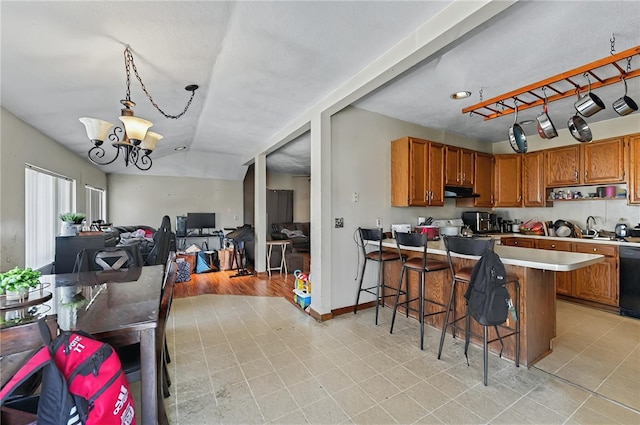 179 Armistice Blvd, Pawtucket, RI 02860 - kitchen featuring brown cabinetry, light countertops, a chandelier, a kitchen breakfast bar, and open floor plan