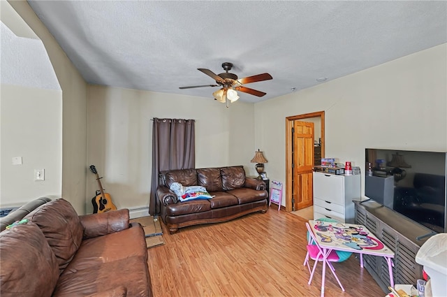 179 Armistice Blvd, Pawtucket, RI 02860 - living room featuring light wood finished floors, ceiling fan, a textured ceiling, and a baseboard heating unit
