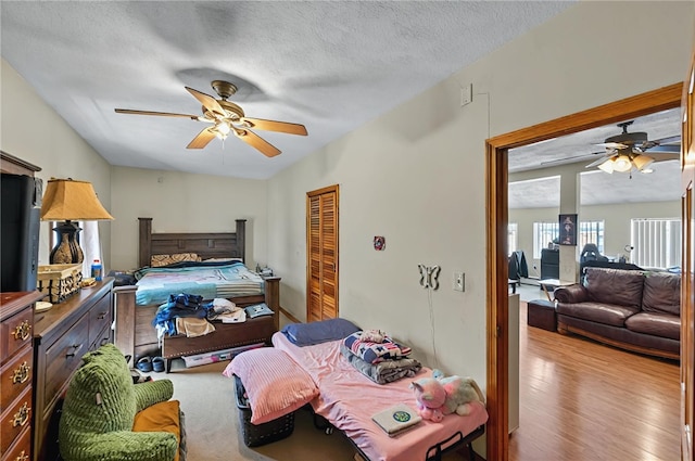 179 Armistice Blvd, Pawtucket, RI 02860 - bedroom featuring a textured ceiling, wood finished floors, a ceiling fan, and a closet