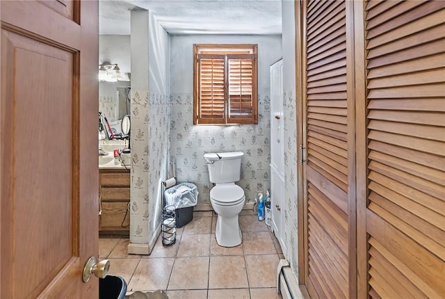 179 Armistice Blvd, Pawtucket, RI 02860 - bathroom with a closet, toilet, tile patterned flooring, vanity, and a baseboard radiator