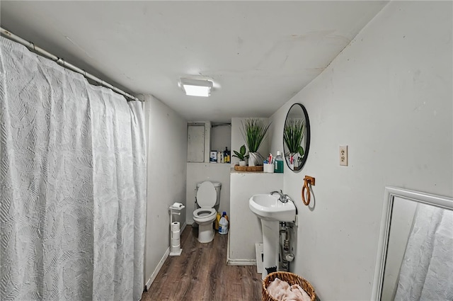 179 Armistice Blvd, Pawtucket, RI 02860 - bathroom with toilet, wood finished floors, a sink, a shower with shower curtain, and baseboards