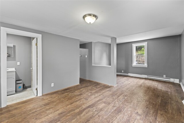 10 Sisson St, West Warwick, RI 02893 - empty room with wood finished floors, baseboard heating, and baseboards