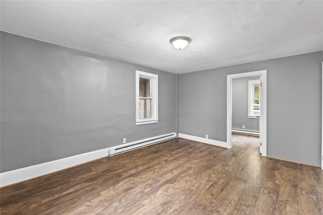 10 Sisson St, West Warwick, RI 02893 - spare room with baseboard heating, wood finished floors, and baseboards
