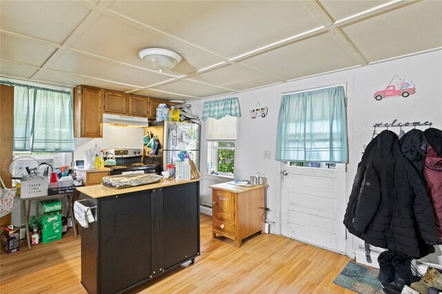 10 Sisson St, West Warwick, RI 02893 - kitchen with under cabinet range hood, stainless steel range with electric cooktop, light wood-style floors, and light countertops