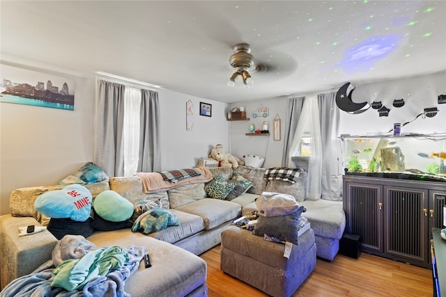 10 Sisson St, West Warwick, RI 02893 - living area with ceiling fan, wood finished floors, and radiator heating unit