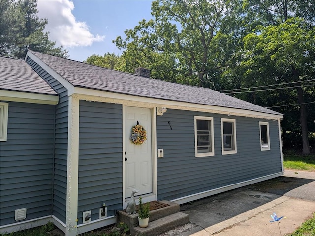94 Mount Pleasant Rd, North Smithfield, RI 02896 - view of front facade featuring roof with shingles and a chimney
