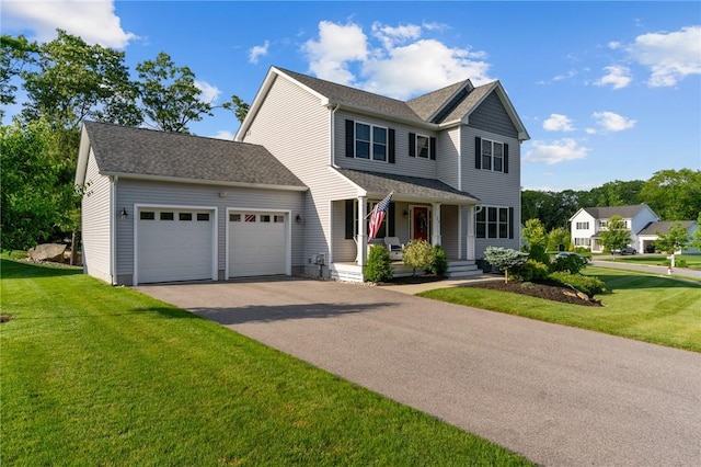25 Ironwood Dr, Coventry, RI 02816 - view of front of home with a porch, a garage, a front yard, driveway, and roof with shingles