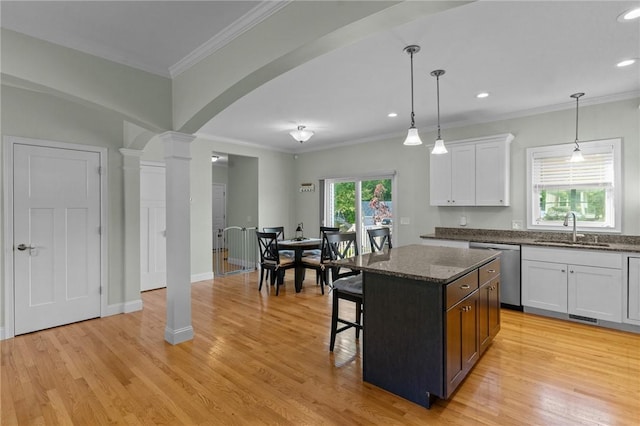 25 Ironwood Dr, Coventry, RI 02816 - kitchen with dishwasher, a sink, decorative columns, white cabinetry, and a breakfast bar