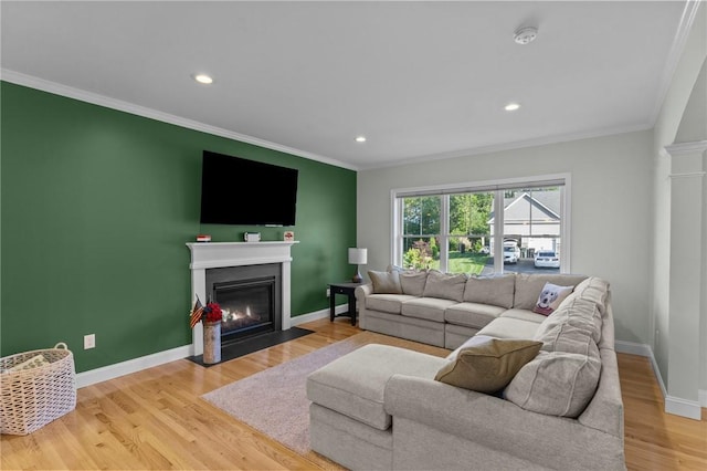 25 Ironwood Dr, Coventry, RI 02816 - living area with a fireplace with flush hearth, crown molding, light wood-style flooring, baseboards, and recessed lighting