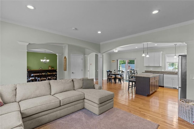 25 Ironwood Dr, Coventry, RI 02816 - living area with ornate columns, arched walkways, ornamental molding, light wood-style floors, and recessed lighting